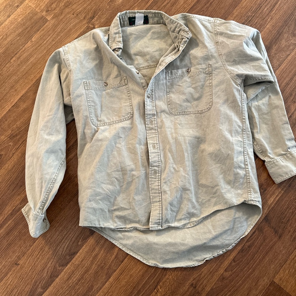 Orvis tan shirt with faint bird detail on back